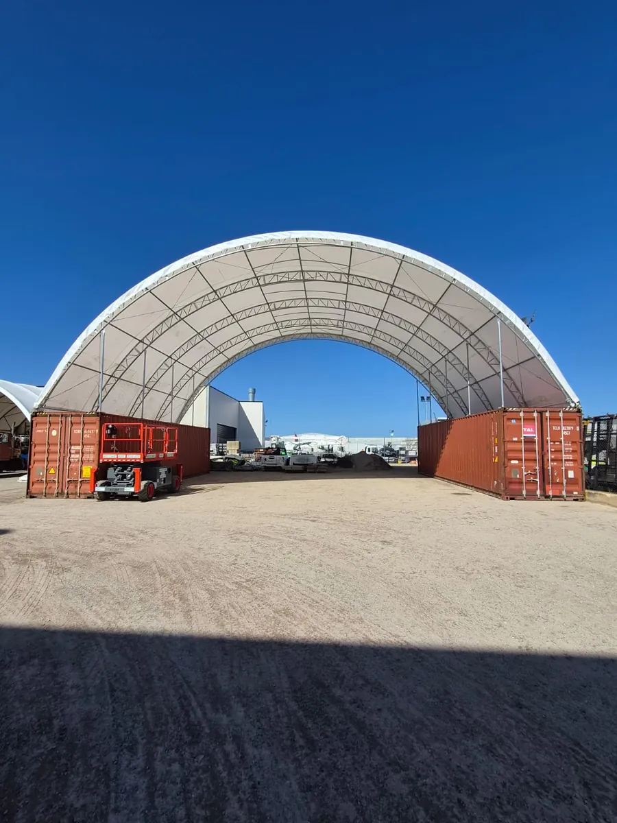 Dome shelter spanning the clear gap between two shipping containers